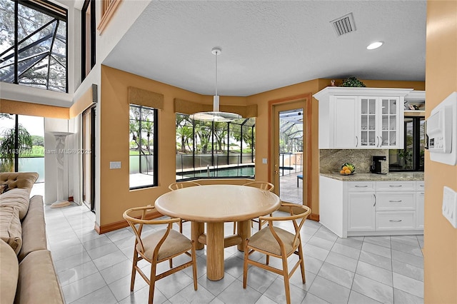 1910 Preston Trl, Coral Springs, FL 33071 - dining space featuring light tile patterned floors, a textured ceiling, and recessed lighting