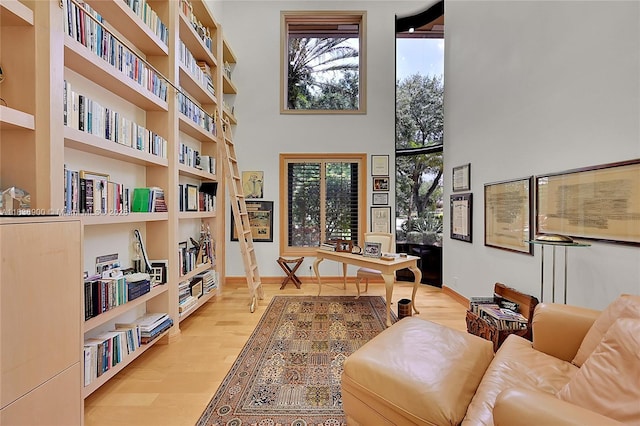 1910 Preston Trl, Coral Springs, FL 33071 - home office with wood finished floors, a towering ceiling, and built in features
