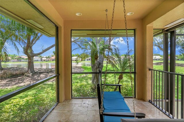 1910 Preston Trl, Coral Springs, FL 33071 - unfurnished sunroom with a water view and stone tile flooring