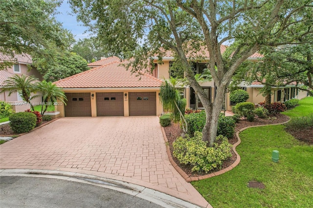 1910 Preston Trl, Coral Springs, FL 33071 - view of front facade with stucco siding, a front yard, driveway, a tiled roof, and a garage