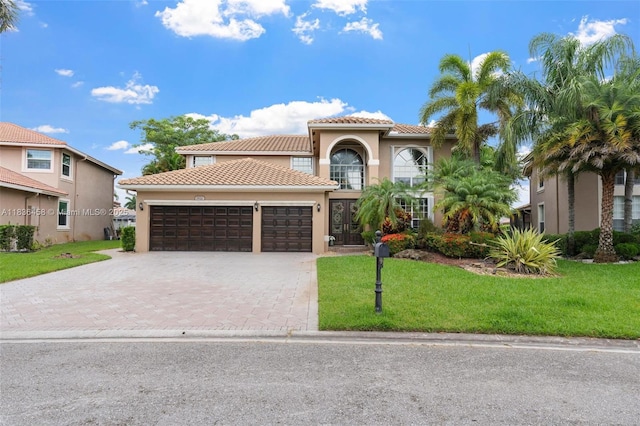 5920 NW 54th Cir, Coral Springs, FL 33067 - mediterranean / spanish-style house with stucco siding, driveway, an attached garage, a tile roof, and a front yard