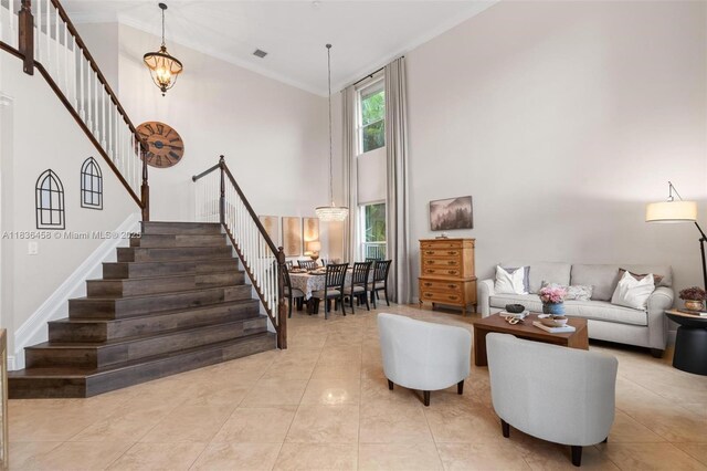 5920 NW 54th Cir, Coral Springs, FL 33067 - tiled living area featuring stairs, high vaulted ceiling, crown molding, and a chandelier