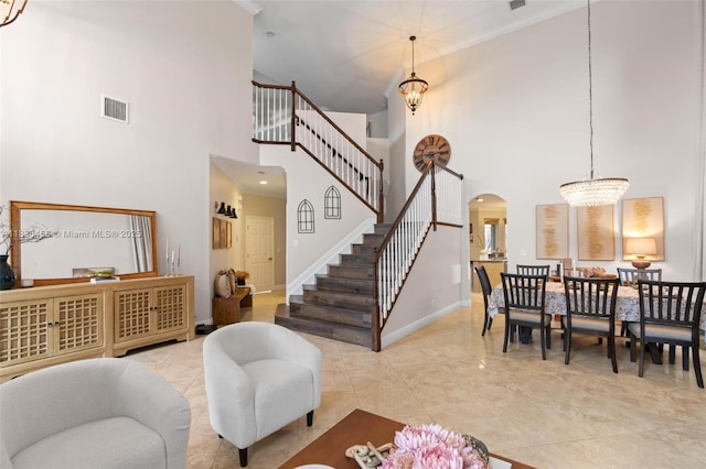 5920 NW 54th Cir, Coral Springs, FL 33067 - living area with a high ceiling, arched walkways, stairway, ornamental molding, and a chandelier