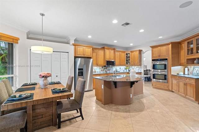 5920 NW 54th Cir, Coral Springs, FL 33067 - kitchen with stainless steel appliances, brown cabinetry, ornamental molding, dark stone countertops, and tasteful backsplash