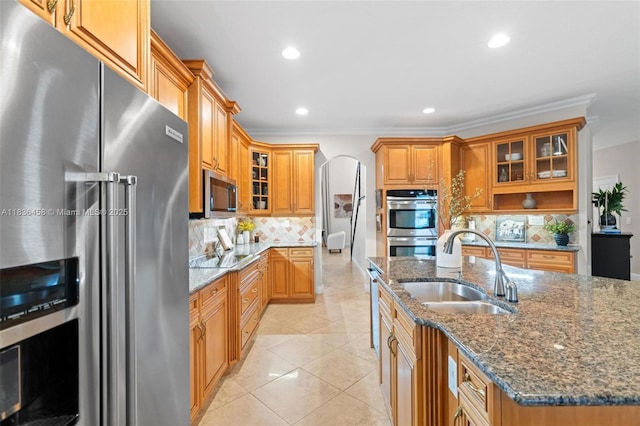 5920 NW 54th Cir, Coral Springs, FL 33067 - kitchen with appliances with stainless steel finishes, decorative backsplash, ornamental molding, recessed lighting, and dark stone counters