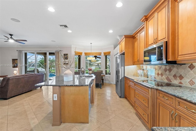 5920 NW 54th Cir, Coral Springs, FL 33067 - kitchen featuring stainless steel appliances, an island with sink, dark stone counters, open floor plan, and decorative backsplash