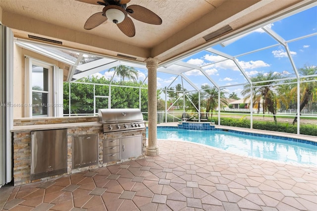 5920 NW 54th Cir, Coral Springs, FL 33067 - outdoor pool featuring an outdoor kitchen, a patio area, a ceiling fan, and glass enclosure