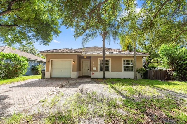 955 S 26th Ave, Hollywood, FL 33020 - single story home with a garage, decorative driveway, stucco siding, and a tile roof