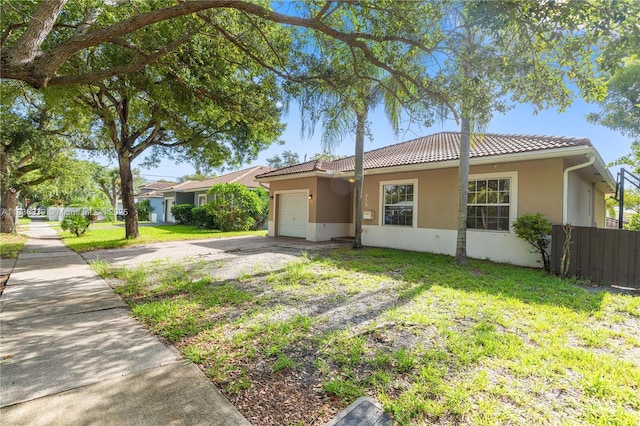955 S 26th Ave, Hollywood, FL 33020 - ranch-style home with an attached garage, a tile roof, stucco siding, and driveway