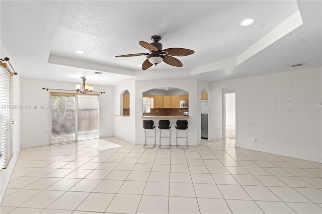 955 S 26th Ave, Hollywood, FL 33020 - unfurnished living room featuring a tray ceiling, a textured ceiling, a ceiling fan, a chandelier, and recessed lighting