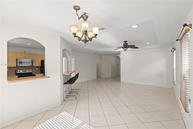 955 S 26th Ave, Hollywood, FL 33020 - unfurnished living room featuring a chandelier, a raised ceiling, arched walkways, and recessed lighting