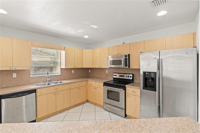 955 S 26th Ave, Hollywood, FL 33020 - kitchen with appliances with stainless steel finishes, light brown cabinetry, light countertops, backsplash, and recessed lighting