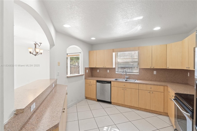 955 S 26th Ave, Hollywood, FL 33020 - kitchen with dishwasher, light brown cabinetry, range, arched walkways, and a textured ceiling