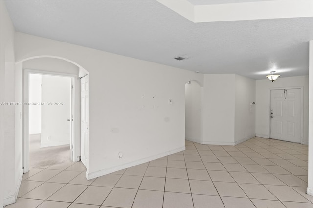 955 S 26th Ave, Hollywood, FL 33020 - empty room featuring arched walkways, a textured ceiling, and light tile patterned floors