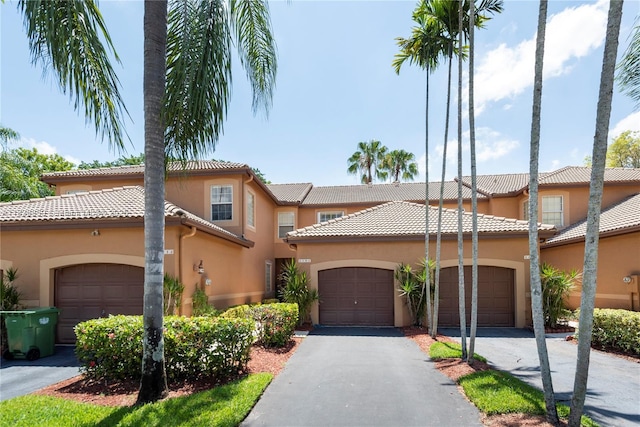 1606 Veracruz Ln, Weston, FL 33327 - view of front of property with stucco siding, a tiled roof, and an attached garage