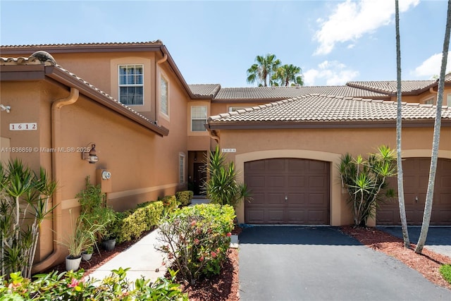 1606 Veracruz Ln, Weston, FL 33327 - view of front of property with stucco siding, an attached garage, asphalt driveway, and a tile roof