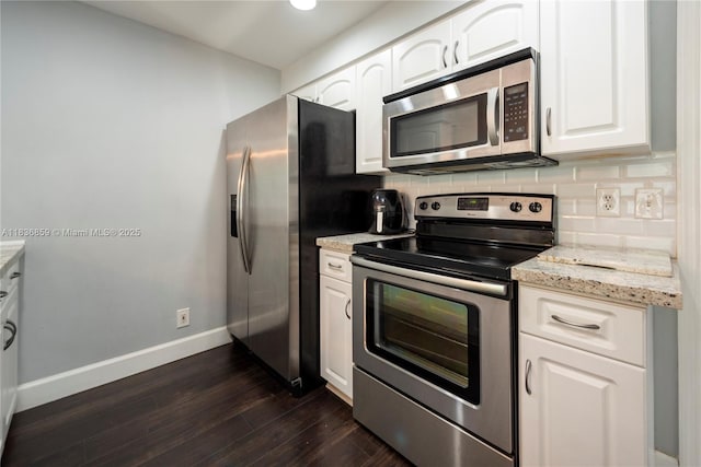 1606 Veracruz Ln, Weston, FL 33327 - kitchen with appliances with stainless steel finishes, tasteful backsplash, dark wood-style floors, white cabinets, and light stone counters