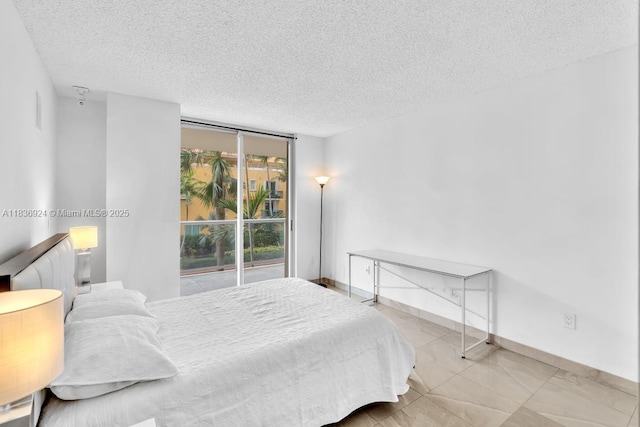 8855 E Collins Ave Unit 2F, Surfside, FL 33154 - bedroom featuring a textured ceiling and a wall of windows
