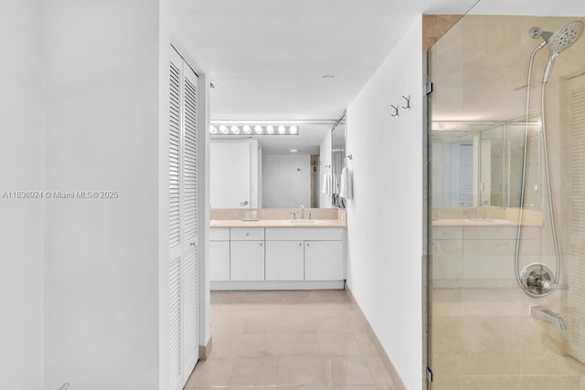 8855 E Collins Ave Unit 2F, Surfside, FL 33154 - bathroom featuring a closet, a stall shower, vanity, and tile patterned floors