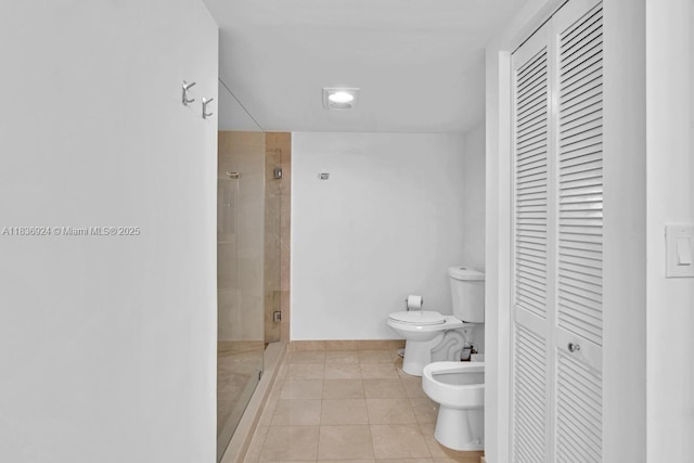 8855 E Collins Ave Unit 2F, Surfside, FL 33154 - bathroom with a closet, a bidet, a shower stall, and tile patterned flooring