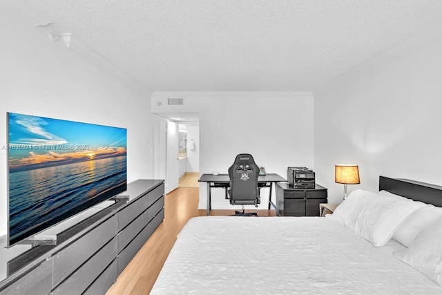 8855 E Collins Ave Unit 2F, Surfside, FL 33154 - bedroom featuring light wood-style flooring, a textured ceiling, and ornamental molding