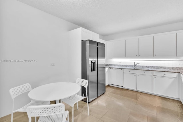 8855 E Collins Ave Unit 2F, Surfside, FL 33154 - kitchen with stainless steel fridge with ice dispenser, dishwasher, white cabinetry, light stone counters, and a textured ceiling