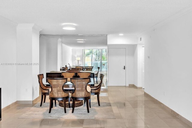 8855 E Collins Ave Unit 2F, Surfside, FL 33154 - dining space featuring a textured ceiling, ornamental molding, and light tile patterned flooring