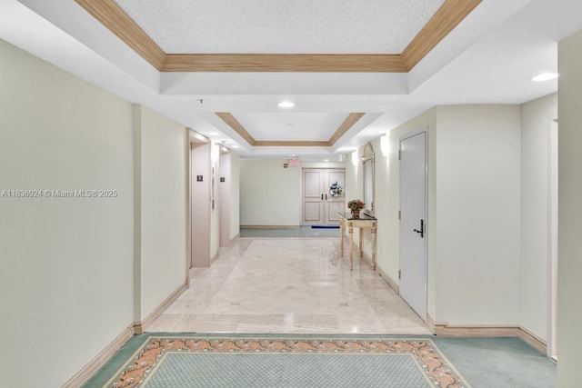 8855 E Collins Ave Unit 2F, Surfside, FL 33154 - hallway featuring a tray ceiling, crown molding, and light marble finish floors