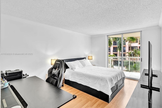 8855 E Collins Ave Unit 2F, Surfside, FL 33154 - bedroom with a textured ceiling, wood finished floors, and access to outside