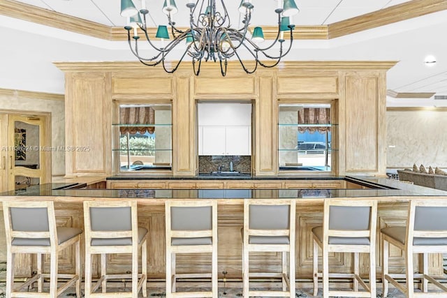 8855 E Collins Ave Unit 2F, Surfside, FL 33154 - bar featuring crown molding, a chandelier, and tasteful backsplash