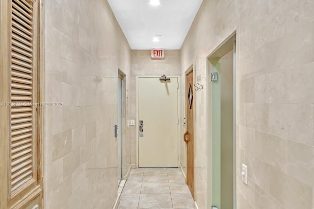 8855 E Collins Ave Unit 2F, Surfside, FL 33154 - hall featuring tile walls, recessed lighting, and light tile patterned floors
