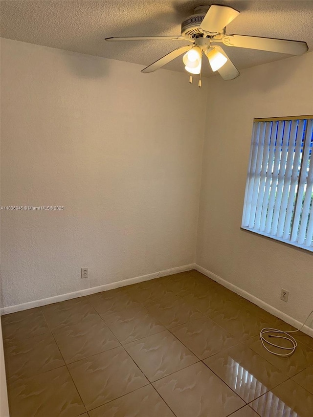 5201 SW 31st Ave Unit 112, Dania Beach, FL 33312 - spare room featuring ceiling fan, a textured ceiling, and dark tile patterned flooring