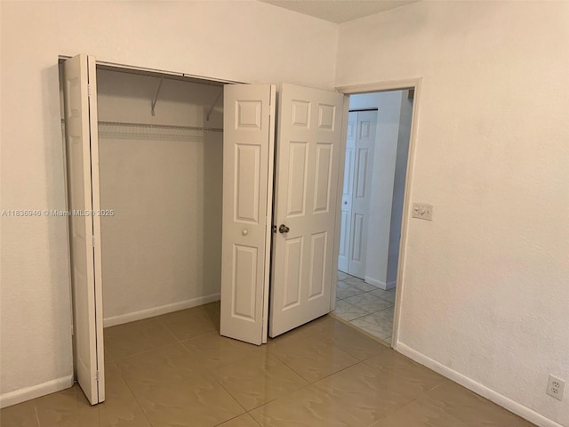 5201 SW 31st Ave Unit 112, Dania Beach, FL 33312 - unfurnished bedroom with a closet and light tile patterned floors