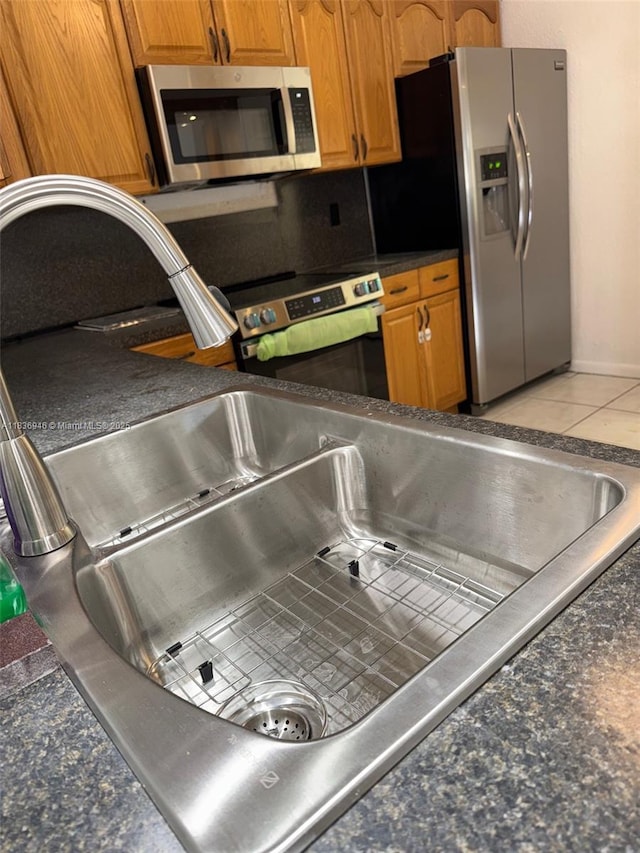 5201 SW 31st Ave Unit 112, Dania Beach, FL 33312 - kitchen with appliances with stainless steel finishes, dark countertops, and brown cabinets