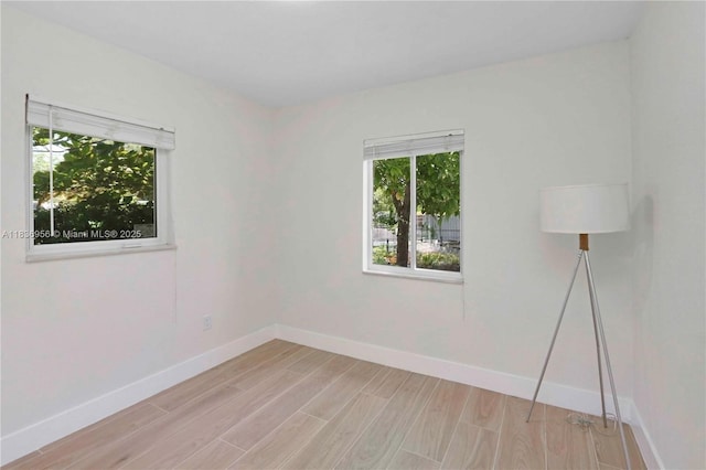 990 NE 159th St, North Miami Beach, FL 33162 - empty room with healthy amount of natural light and light wood-style flooring