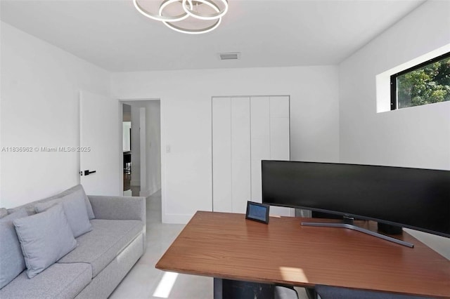 231 NE 45th St, Miami, FL 33137 - home office with a chandelier and concrete floors