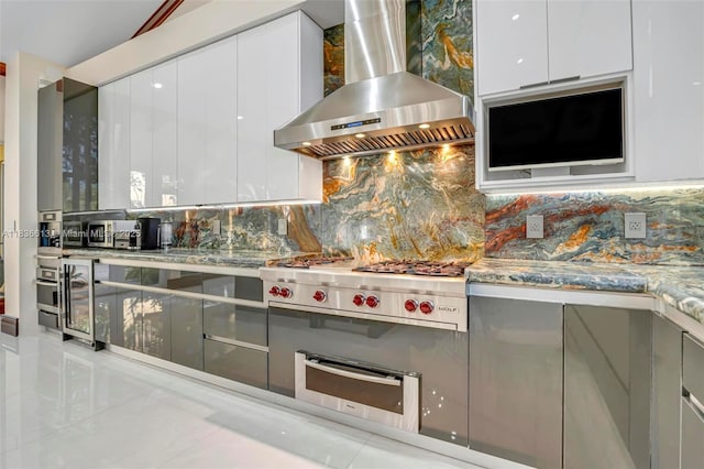 5800 SW 178th Ave, Southwest Ranches, FL 33331 - kitchen with wall chimney range hood, modern cabinets, a warming drawer, stainless steel gas cooktop, and backsplash