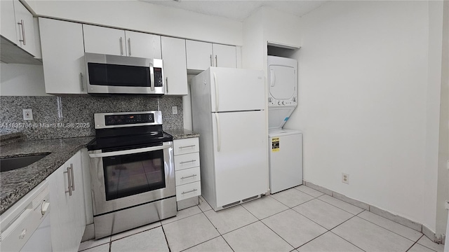 9277 SW 138th Pl Unit 9277, Miami, FL 33186 - kitchen with stainless steel appliances, stacked washer / drying machine, tasteful backsplash, and white cabinets