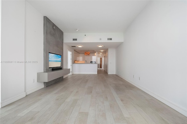 2681 N Flamingo Rd Unit 2708S, Sunrise, FL 33323 - unfurnished living room with light wood-style flooring and baseboards