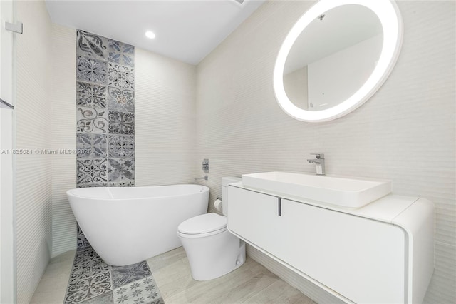 2681 N Flamingo Rd Unit 2708S, Sunrise, FL 33323 - bathroom featuring tile walls, a soaking tub, and vanity