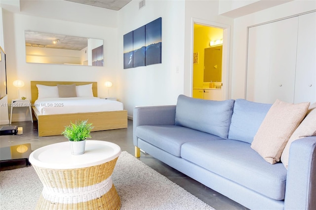 133 NE 2nd Ave Unit 1410, Miami, FL 33132 - bedroom with concrete floors, ensuite bathroom, and a closet