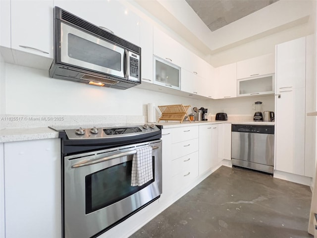 133 NE 2nd Ave Unit 1410, Miami, FL 33132 - kitchen with stainless steel appliances, concrete floors, light countertops, and white cabinetry