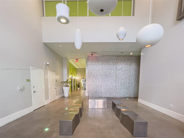 133 NE 2nd Ave Unit 1410, Miami, FL 33132 - hall with finished concrete flooring and a high ceiling