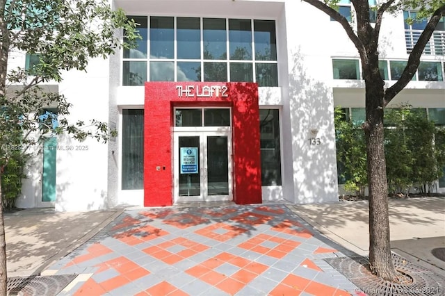 133 NE 2nd Ave Unit 1410, Miami, FL 33132 - doorway to property with stucco siding and french doors