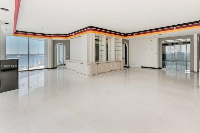 3802 NE 207th St Unit 601, Aventura, FL 33180 - unfurnished room featuring arched walkways, a tray ceiling, and light tile patterned floors