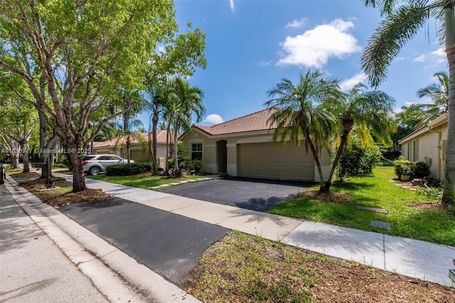 2020 Andromeda Ln, Weston, FL 33327 - mediterranean / spanish-style home featuring stucco siding, driveway, a garage, a front lawn, and a tile roof