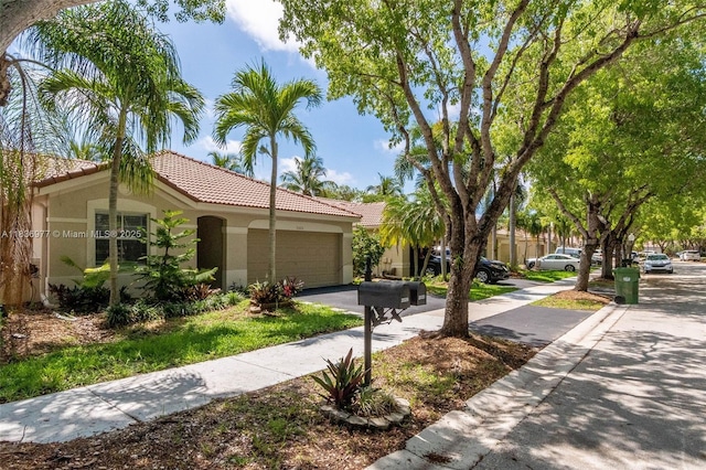 2020 Andromeda Ln, Weston, FL 33327 - view of front of home featuring stucco siding, a tiled roof, asphalt driveway, and an attached garage