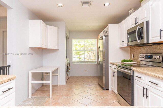 2020 Andromeda Ln, Weston, FL 33327 - kitchen with stainless steel appliances, white cabinetry, recessed lighting, backsplash, and light tile patterned floors