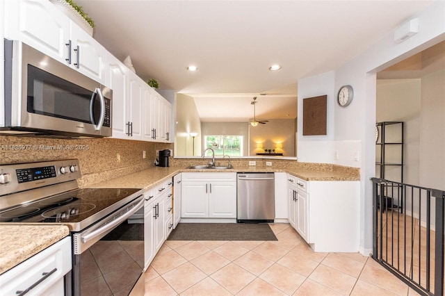 2020 Andromeda Ln, Weston, FL 33327 - kitchen featuring appliances with stainless steel finishes, backsplash, white cabinetry, light tile patterned floors, and recessed lighting