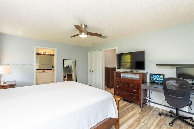 2020 Andromeda Ln, Weston, FL 33327 - bedroom featuring light wood finished floors, an office area, connected bathroom, ceiling fan, and a textured ceiling